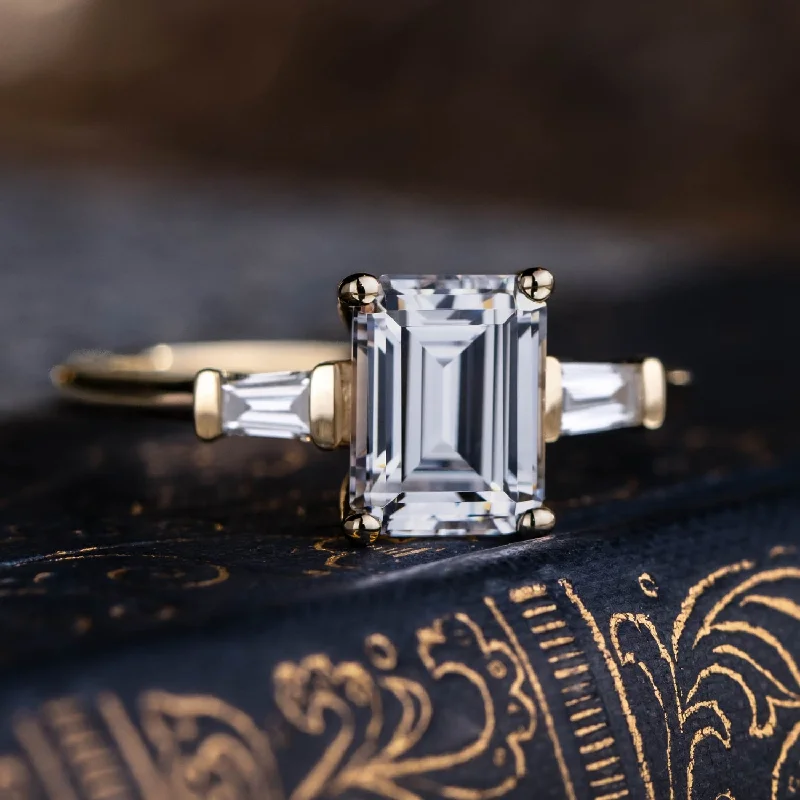 engagement-heart-platinum-ring-The Charlotte - Three Stone Emerald Cut Diamond Engagement Ring