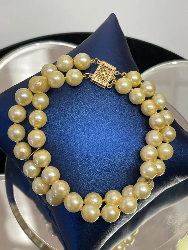 Ladies bracelets with burst charms -14 KARAT YELLOW GOLD AND DOUBLE STRAND PEARL BRACELET